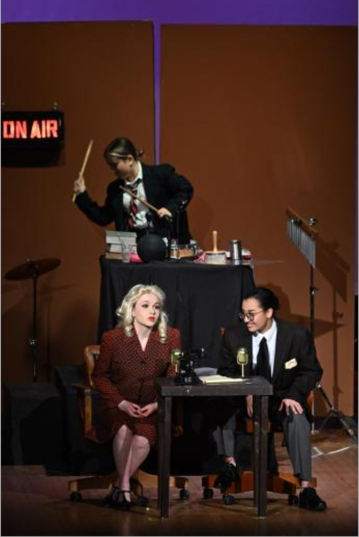 An On Air sign is pictured somewhere on the stage, and let up red.