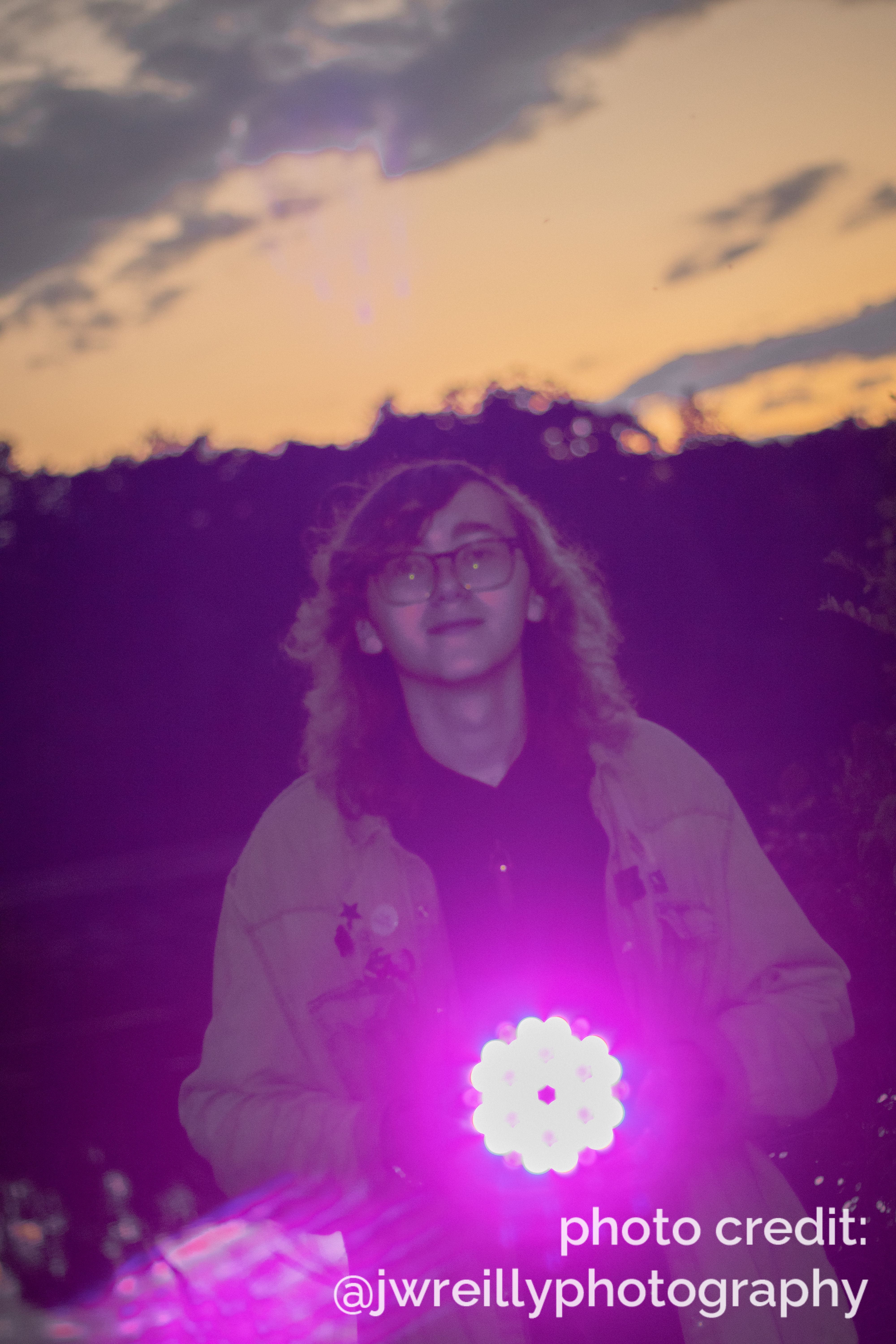 Dave holds a purple par light and points it at the camera
