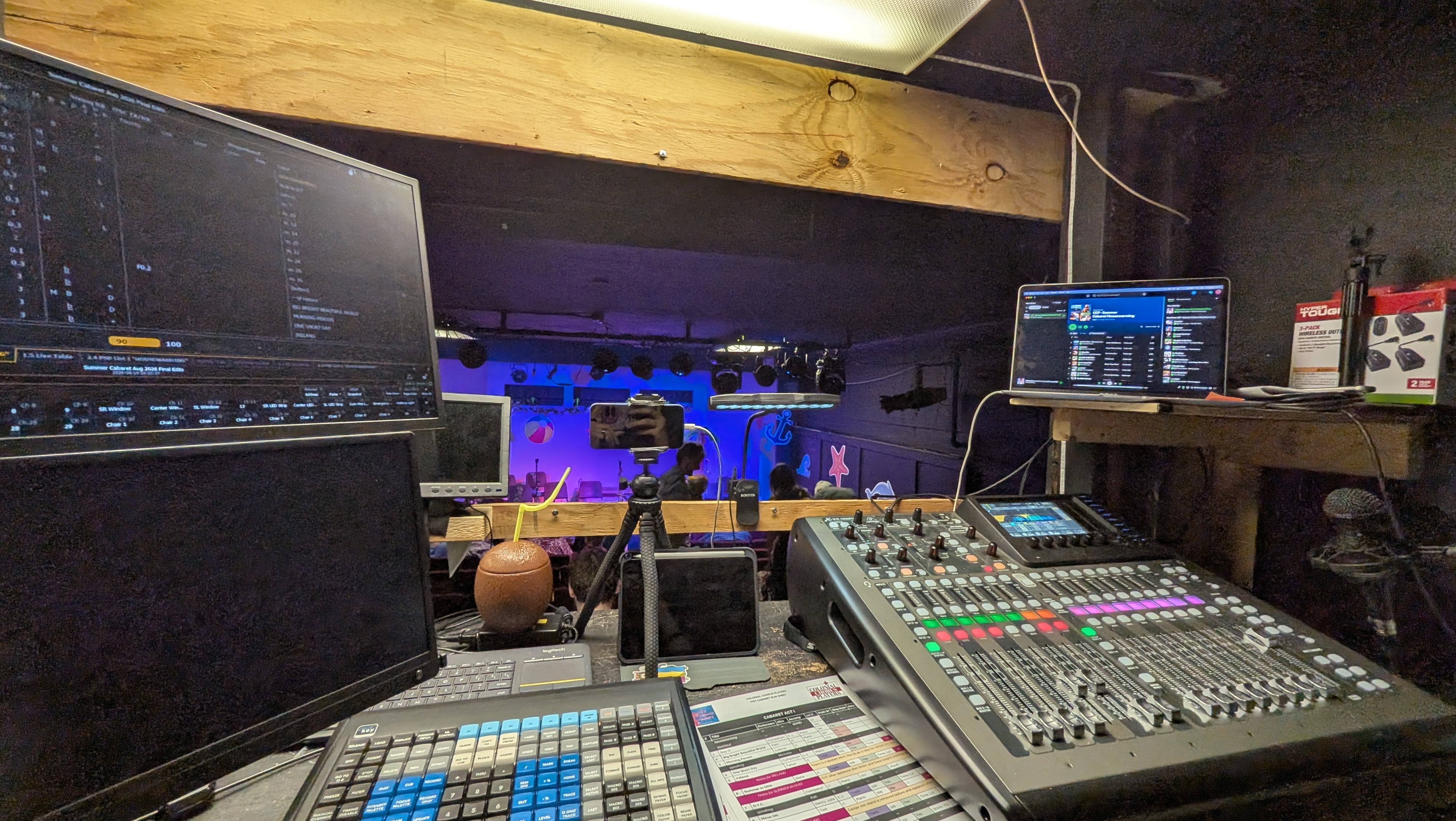 FOH for the cabaret. A computer running ETCnomad with a cmd_key is on the left, a Behringer X32 is on the right, and a computer running housewarming music is above the X32.