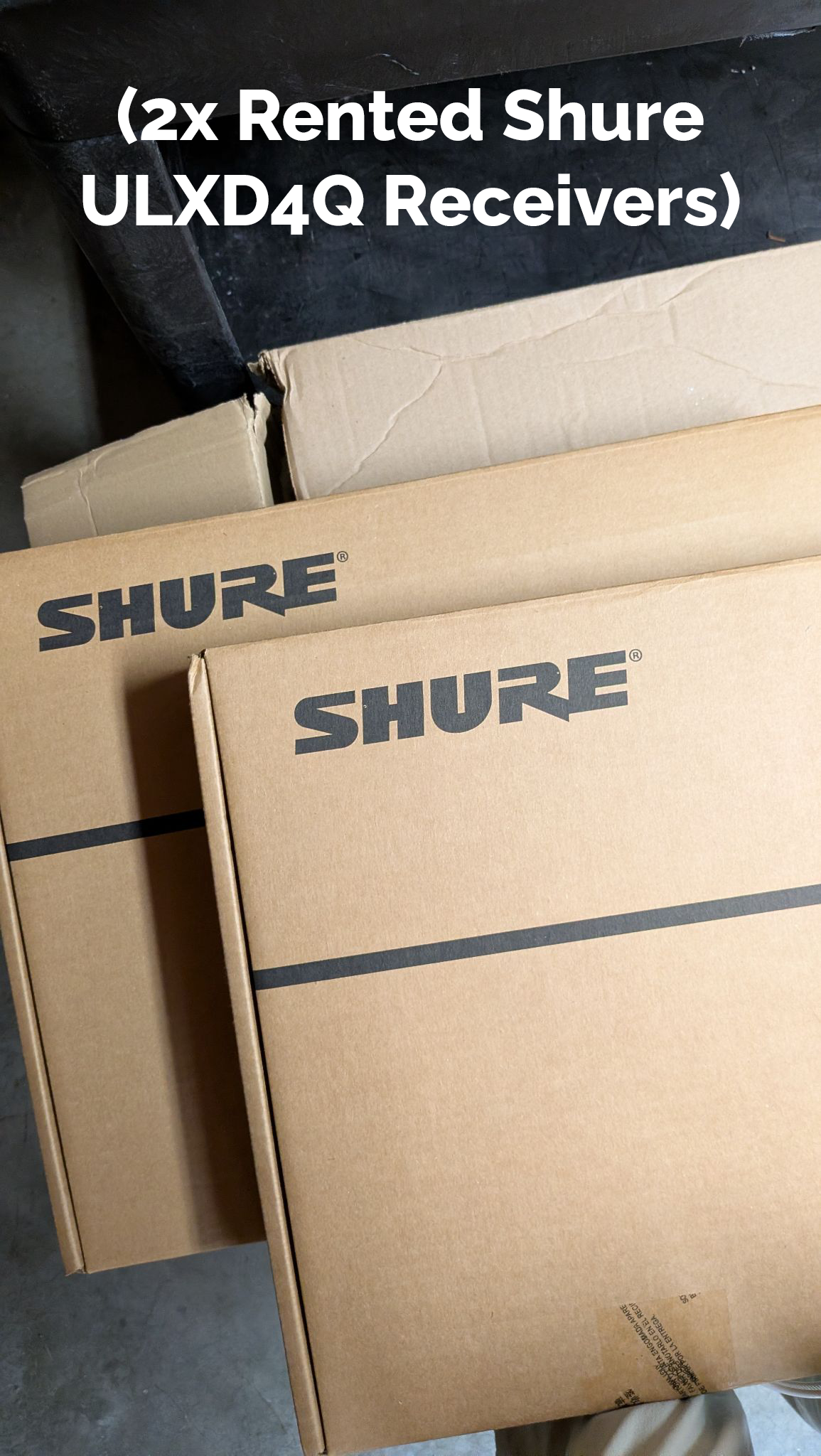 Two rented Shure ULXD4Q Receivers in their boxes