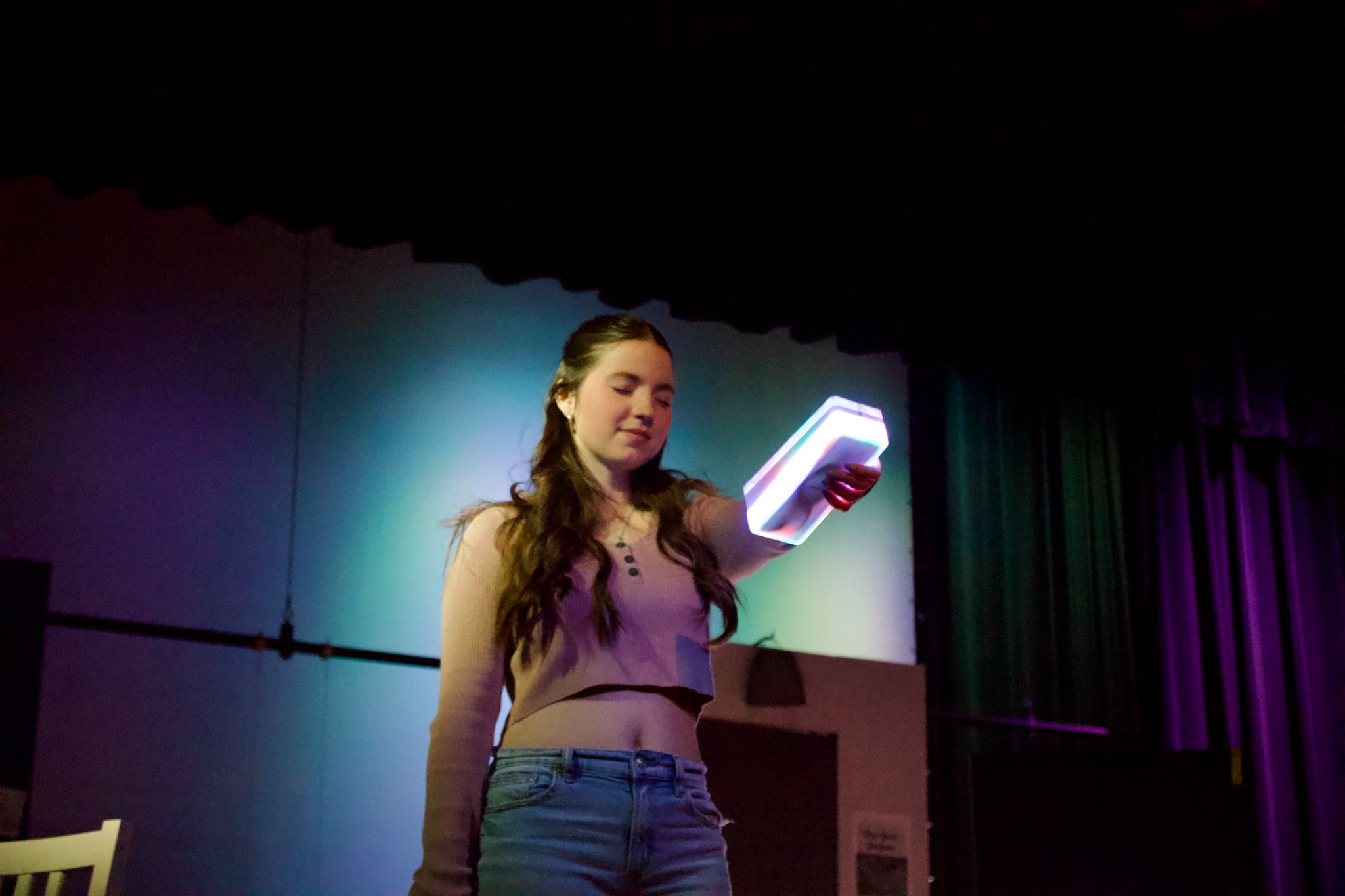 A character from Make 'Em Laugh holding a light-up remote